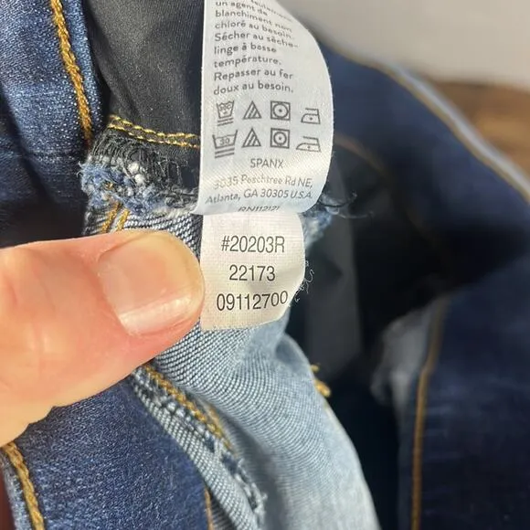 SPANX Distressed Ankle Skinny Jeans in Medium Wash.